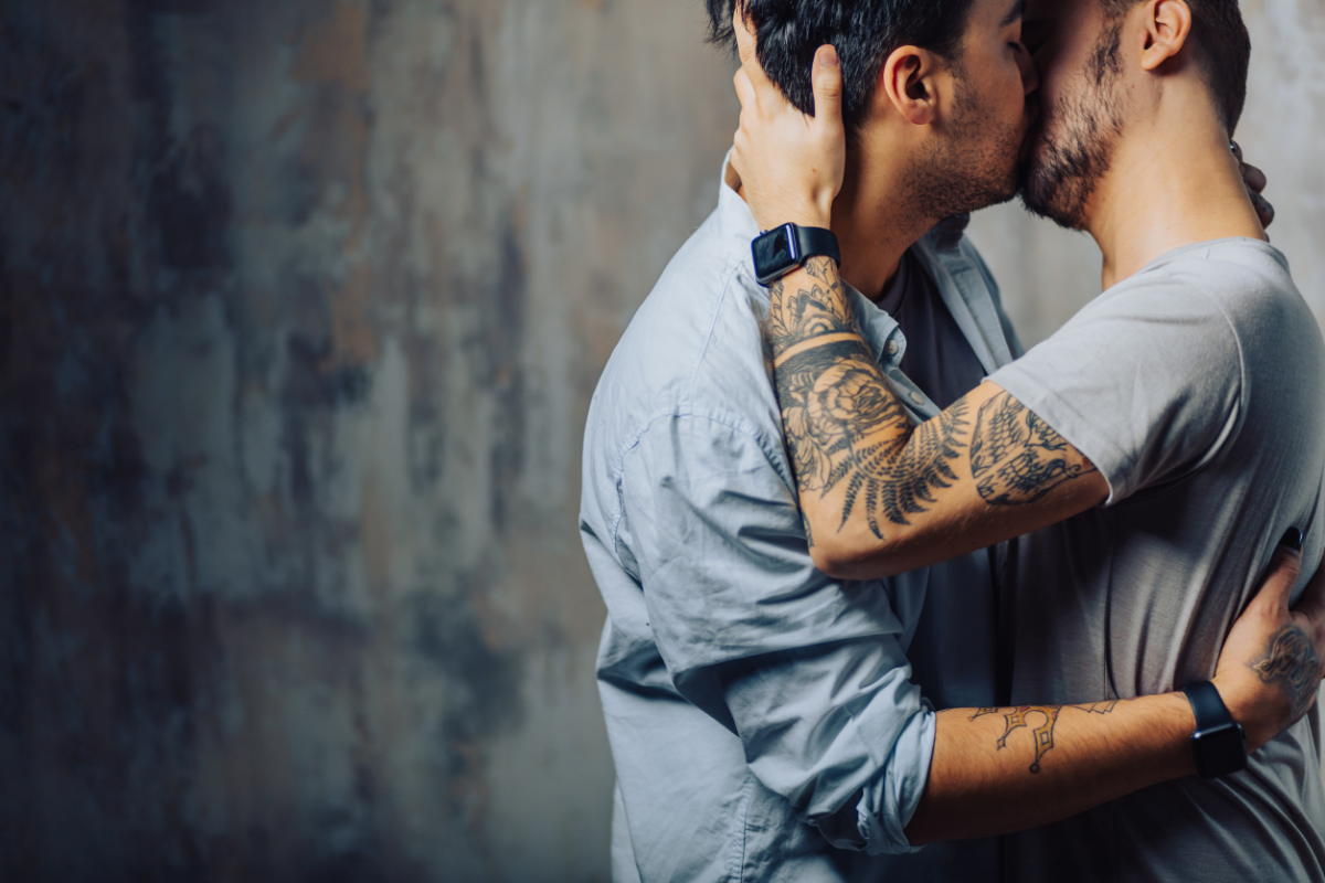 Gay men passionately kissing